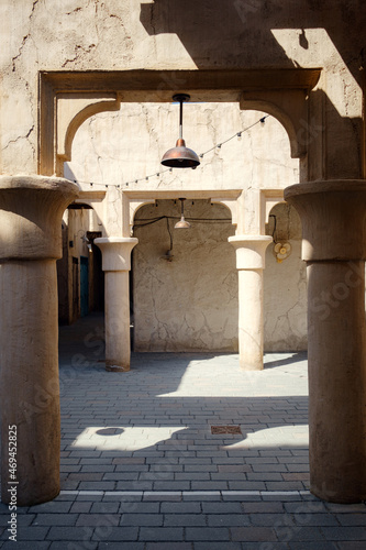 Old Dubai. Traditional Arabic streets in historical Al Fahidi district, Al Bastakiya. Dubai, United Arab Emirates. Bright sunny afternoon on a stone street in a traditional oriental city. photo