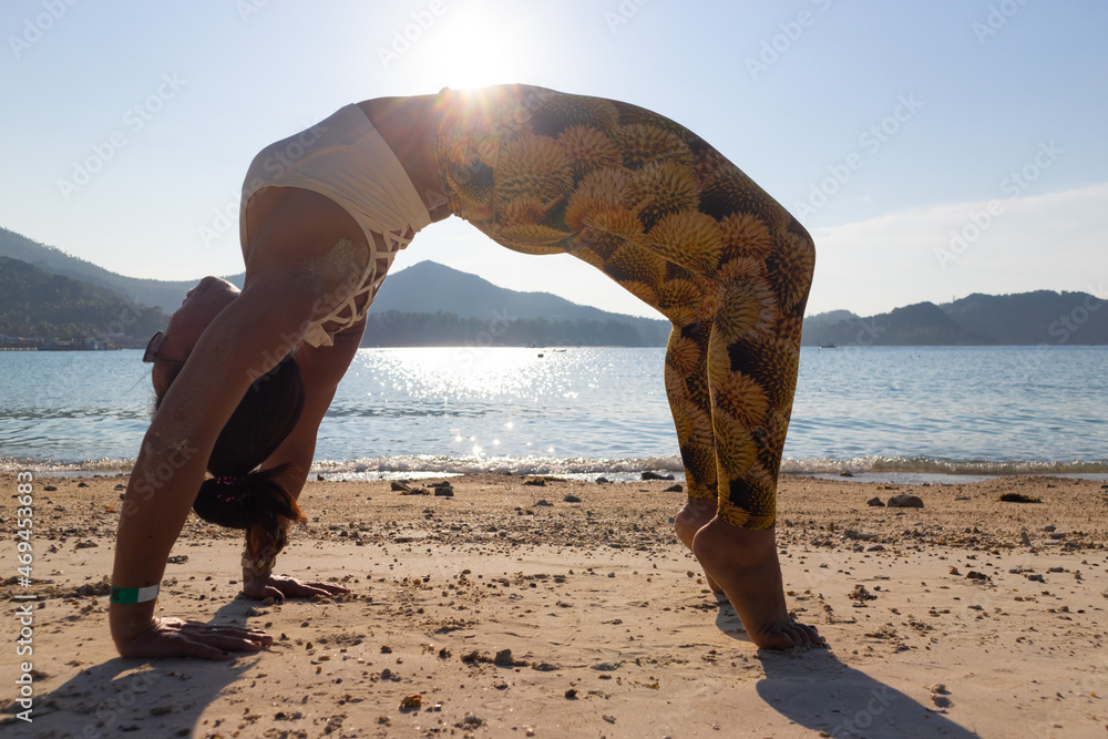 Wheel Pose Asian Woman Doing Yoga Poses On A Beach In Koh Pha Ngan wheel-pose-asian-woman-doing-yoga-poses-on-a-beach-in-koh-pha-ngan