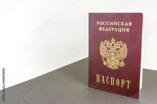 The Russian passport stands upright on the table.