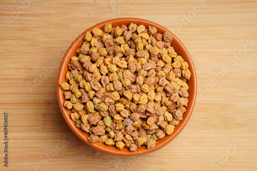 Dry chickpea in bowl on wooden background photo