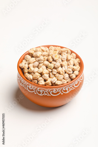 Dry chickpea in bowl on white background.