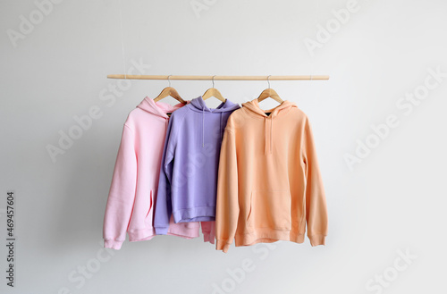 Wallpaper Mural Modern hoodies hanging on light wall Torontodigital.ca