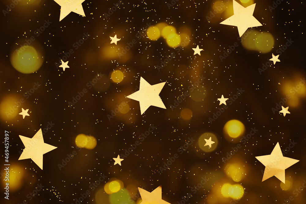 Christmas or New Year background - Golden shiny stars on black background. Starry sky. Christmas or New Year background - Golden shiny stars on black background. Starry sky.