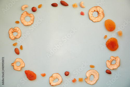 Circle of healthy snacks of dry fruits. Proper nutrition, healthy food concept. Dry fruits apple slices, dried apricots, almonds, cashews, raisins. Template for design.