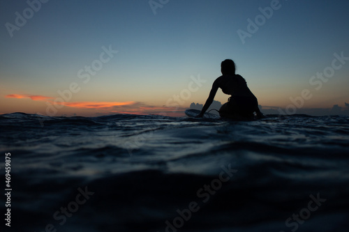 beautiful girl with a surfboard at sunset. © alexzhilkin