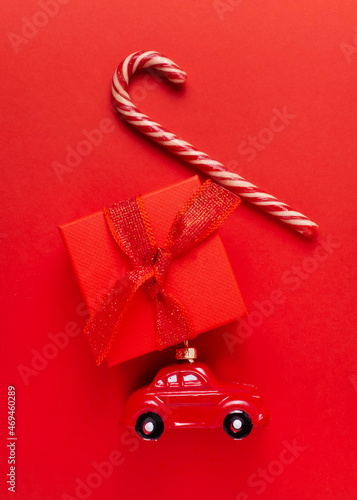 Car, gift, lollipop, candy on a red background.