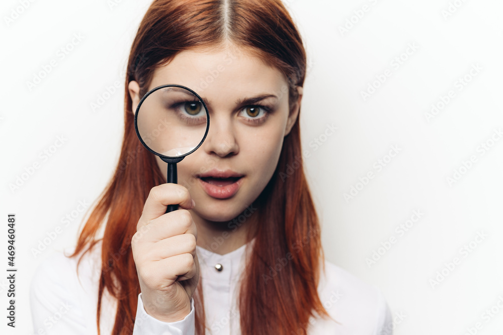 pretty woman grimacing with magnifying glass near face pretty woman grimacing with magnifying glass near face