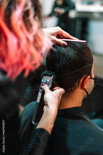 Male client getting haircut by hairdresser