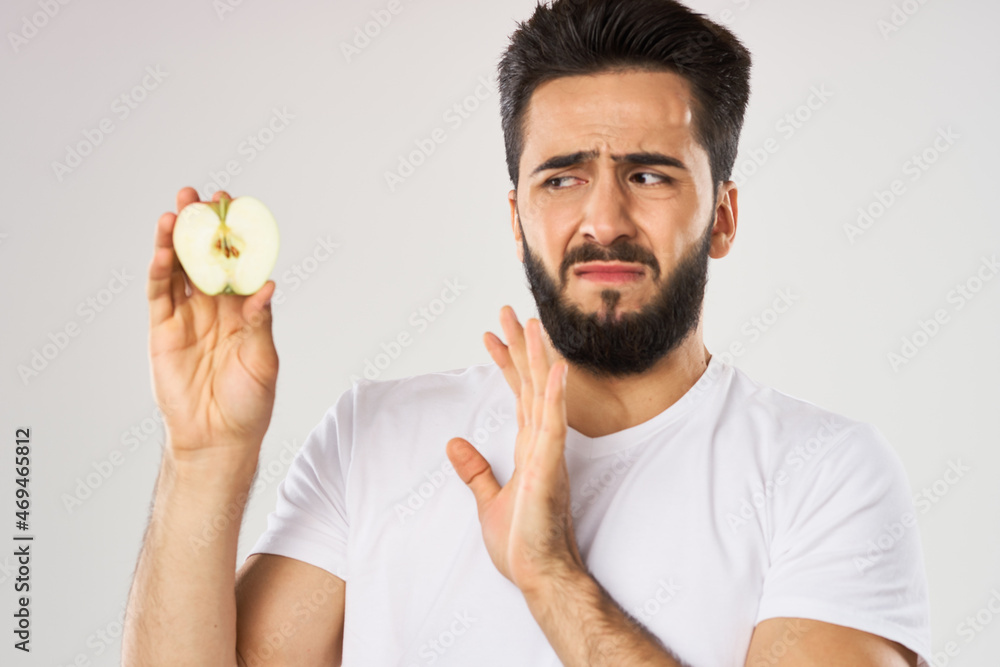 emotional bearded man with apple in his hands fruit snack emotional bearded man with apple in his hands fruit snack