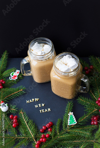 marshmellou cocoa, Christmas tree with decorations on a black background. The inscription Happy New Year photo