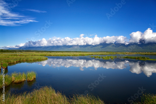 Landscape with mountains reflecting in the water on summer day. Buryatia, Tunkinskaya valley photo