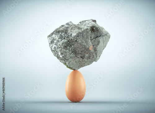 Rock standing on egg. photo