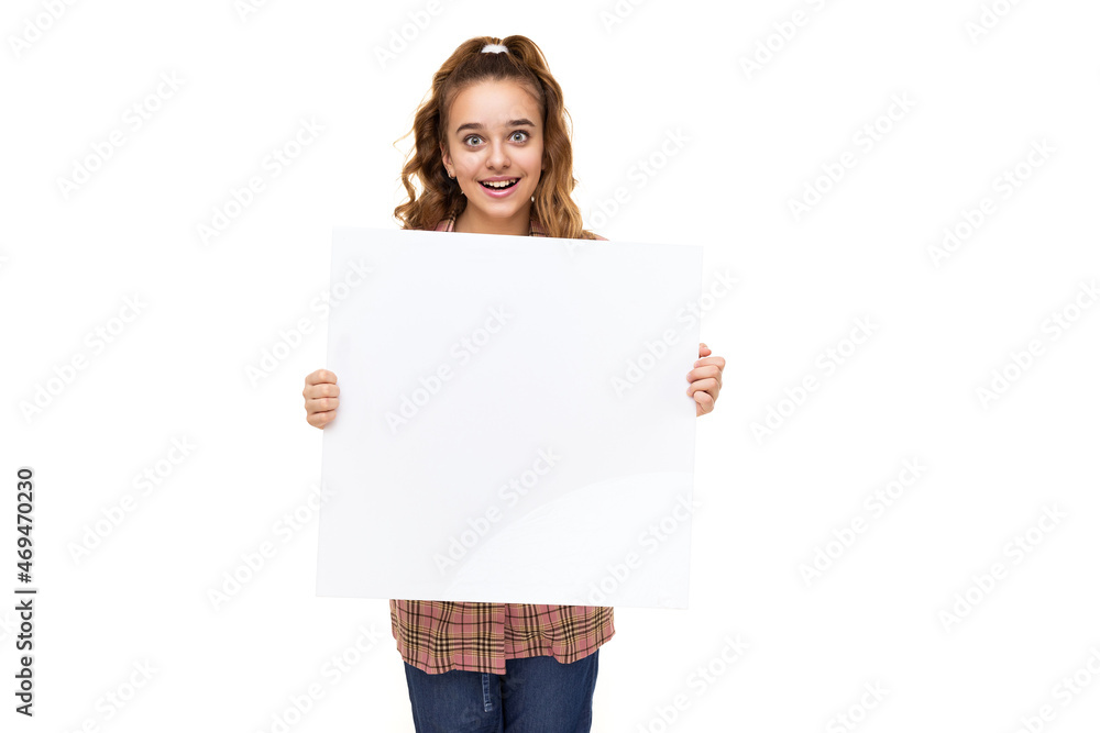 Beautiful amazing cute adorable smiling happy brunette teenage girl with ponytail in stylish plaid jacket, white t-shirt and holds white blank sheet isolated on white background with empty space for Beautiful amazing cute adorable smiling happy brunette teenage girl with ponytail in stylish plaid jacket, white t-shirt and holds white blank sheet isolated on white background with empty space for