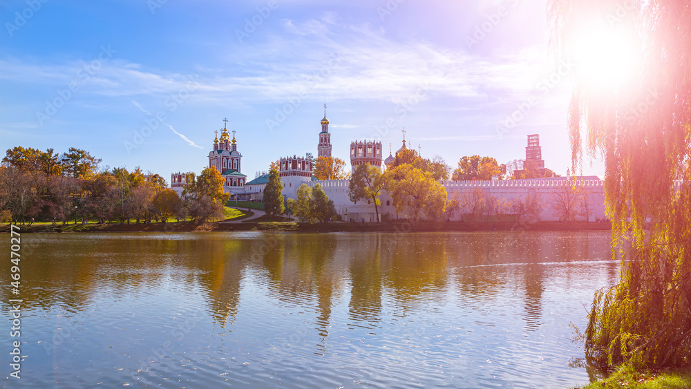 View of the Novodevichy convent (Bogoroditse-Smolensky monastery) and the big Novodevichy pond on a sunny autumn day. Moscow, Russia. UNESCO world heritage site