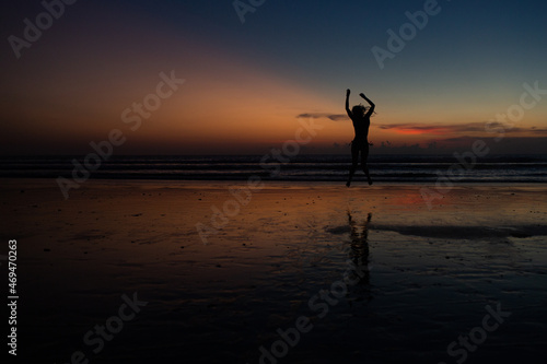 beautiful girl dancing at sunset.