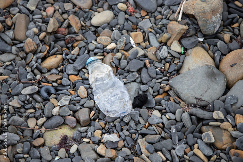 An old plastic bottle washed up by the sea on the shore An old plastic bottle washed up by the sea on the shore