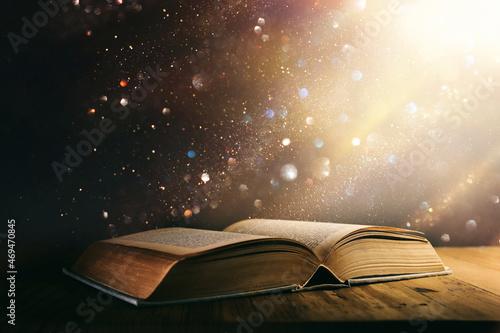 Εκτύπωση καμβά image of open antique book on wooden table with glitter overlay