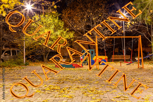 Coronavirus in Moscow, Russia. An empty playground on an autumn night in one of the residential areas. Quarantine sign. Concept of COVID pandemic and travel