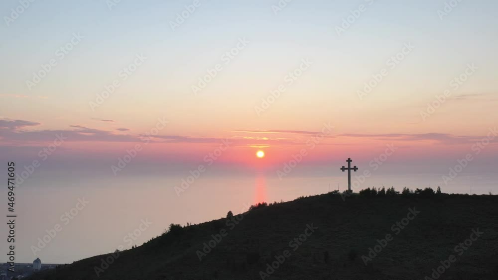 Aerial view of the mountains, the city and the cross on the mountain. Sight of Batumi - Cross. Sunset over the sea against the background of the cross. 4K video. Aerial view of the mountains, the city and the cross on the mountain. Sight of Batumi - Cross. Sunset over the sea against the background of the cross. 4K video.