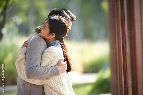 Принти на полотні young asian couple hugging outdoors