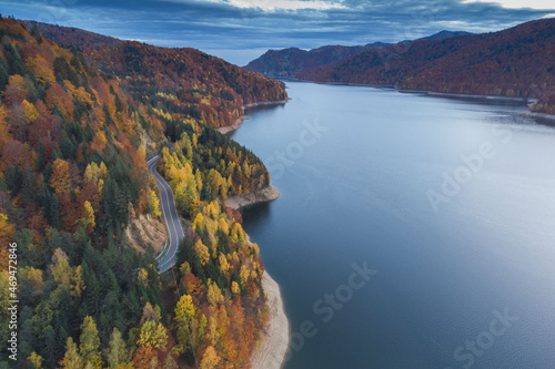 Aerial view of colorful mountain road, at Vidraru Dam - Transfagarasan Highway, Romania, during autumn