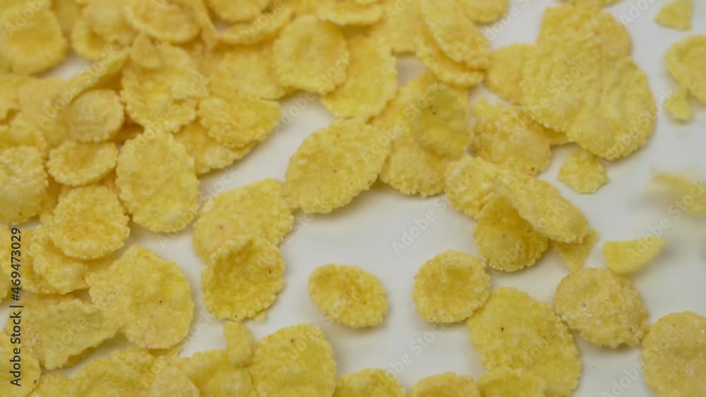 Corn Flakes Are Falling, Close-up, Macro, Slow Motion. Background of Falling CornFlakes, Isolated. Healthy Breakfast, Healthy Vegetarian Food. Corn Flakes Are Falling, Close-up, Macro, Slow Motion. Background of Falling CornFlakes, Isolated. Healthy Breakfast, Healthy Vegetarian Food.