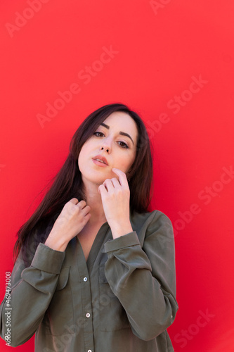 Young Brunette elegant woman wearing a casual green shirt