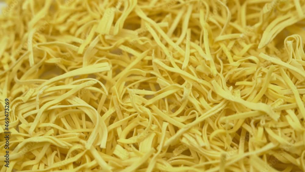 Uncooked Noodles, Egg Noodles, Macro. Noodles, Pasta Are Rotated, Isolated. Healthy Food, A Natural Ingredient for Cooking. Asian, Italian Cuisine. Uncooked Noodles, Egg Noodles, Macro. Noodles, Pasta Are Rotated, Isolated. Healthy Food, A Natural Ingredient for Cooking. Asian, Italian Cuisine.