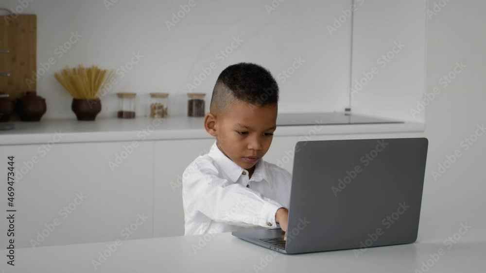 Online Education. Cute Little Black Boy Typing On Laptop Computer At Home Online Education. Cute Little Black Boy Typing On Laptop Computer At Home