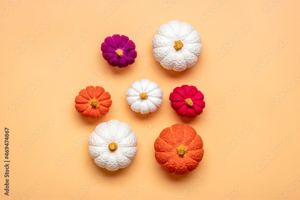 Orange, white, purple pumpkin and maple leaves isolated on beige background Top view Flat lay Hello autumn, happy thanksgiving concept Holiday card Orange, white, purple pumpkin and maple leaves isolated on beige background Top view Flat lay Hello autumn, happy thanksgiving concept Holiday card