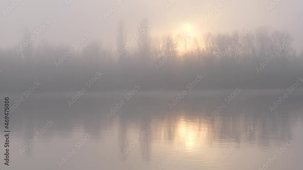 fog over the river a fisherman in a boat at sunset in November fog over the river a fisherman in a boat at sunset in November