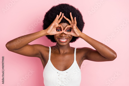 Photo of funny young wavy hairdo lady show glasses wear white top isolated on pastel pink color background