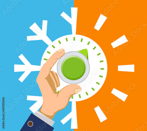Human hand rotates the thermostat regulator.