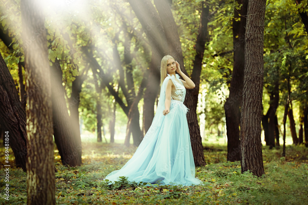 Beautiful girl wearing fairy dress in autumn forest