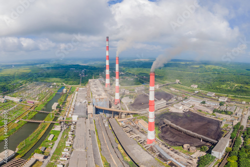 plant pipe with smoke against blue sky