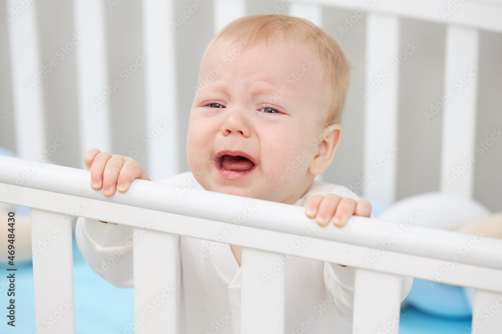 The little baby is crying in the crib, wants to sleep and milk teeth are climbing. Pediatric problems The little baby is crying in the crib, wants to sleep and milk teeth are climbing. Pediatric problems