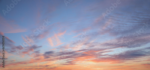 sunset background with p9ink and purple clouds in stripes and blue sky