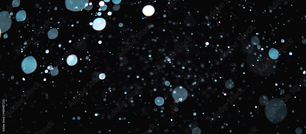 Blurred snowflakes on a dark background. Overlay image for snowfall effect Blurred snowflakes on a dark background. Overlay image for snowfall effect