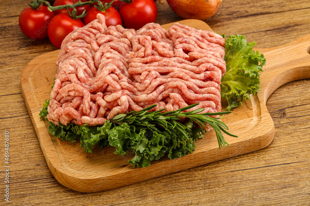 Raw pork minced meat over board Raw pork minced meat over board