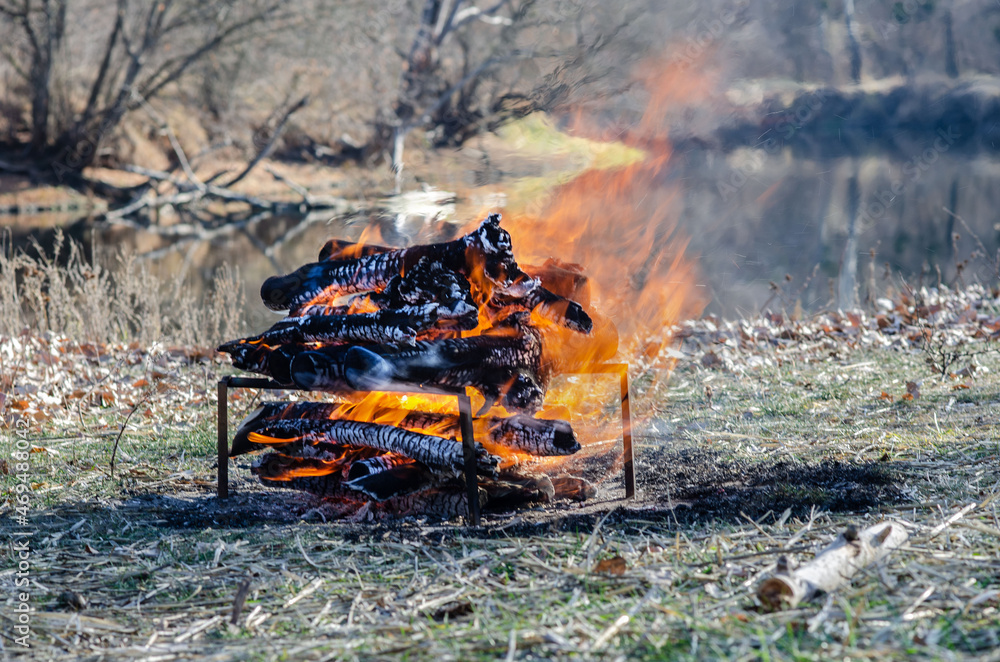 Big bonfire on the river bank, calmness, rest, day, campfire smoke Big bonfire on the river bank, calmness, rest, day, campfire smoke