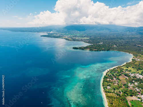 Tropical ocean coast with sandy beach and turquoise ocean, aerial drone view.