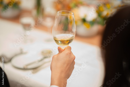 guest hold wine glass in fine dining restaurant