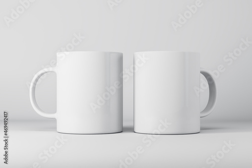 Two empty white mugs or cup on light background with mock up place for your advertisement. 3D Rendering.