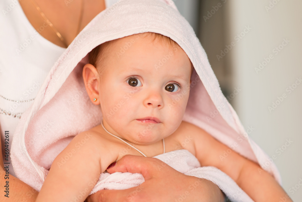 Mom and baby. The baby is wrapped in a towel after the bath. Mom and baby. The baby is wrapped in a towel after the bath.