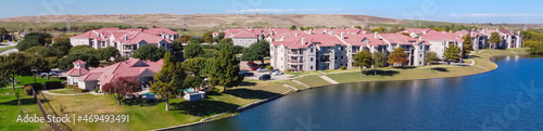 Panorama aerial view lakeside apartment complex with landfill community waste disposal in background