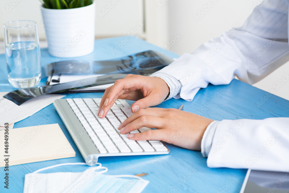 Close-up of doctor hands typing at keyboard Close-up of doctor hands typing at keyboard