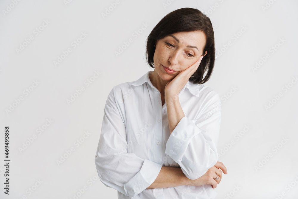 European mature woman propping up her head and looking downward European mature woman propping up her head and looking downward