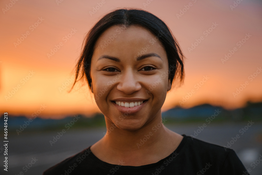 Black brunette woman smiling and looking at camera Black brunette woman smiling and looking at camera
