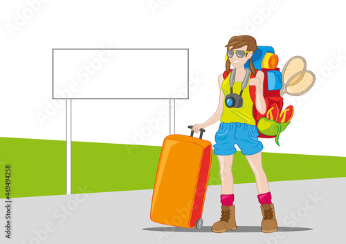 turysta czeka z plecakiem i walizaką przy drodze