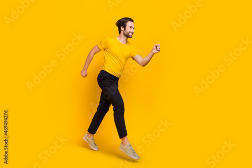 Full body profile side photo of young man go runner look empty space discount isolated over yellow color background © deagreez